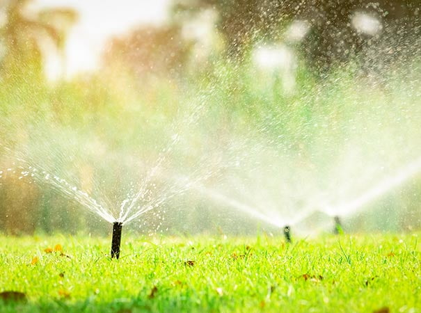 Landscaping sprinkler system blown out with compressed air