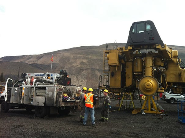 Finning service truck works on heavy machinery in oil & gas field