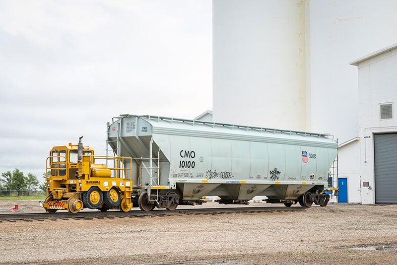 Railcar mover on tracks, side view