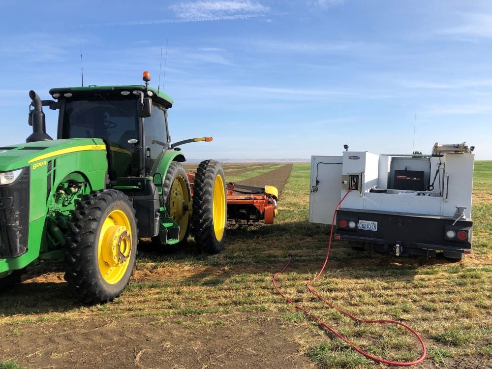 Boorman Farms truck with Multifunction servicing a tractor