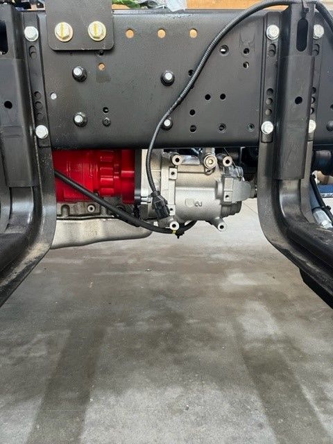 Close up of spline drive air compressor installed on Hyundai EX9