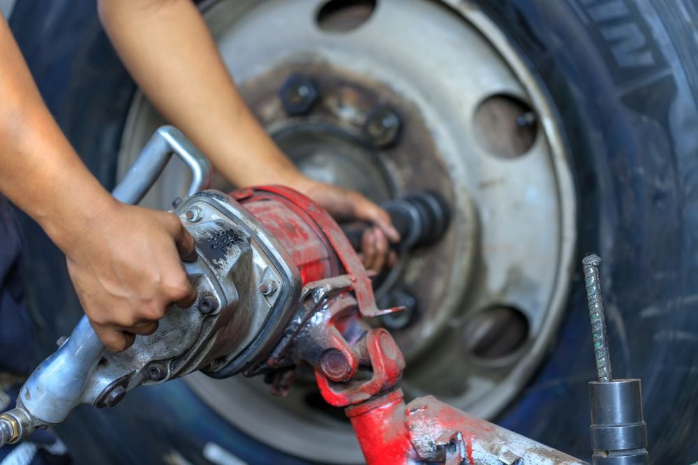 An impact wrench being used to loosen tire